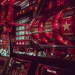 Close-up view of multiple vintage slot machines with vibrant red lights