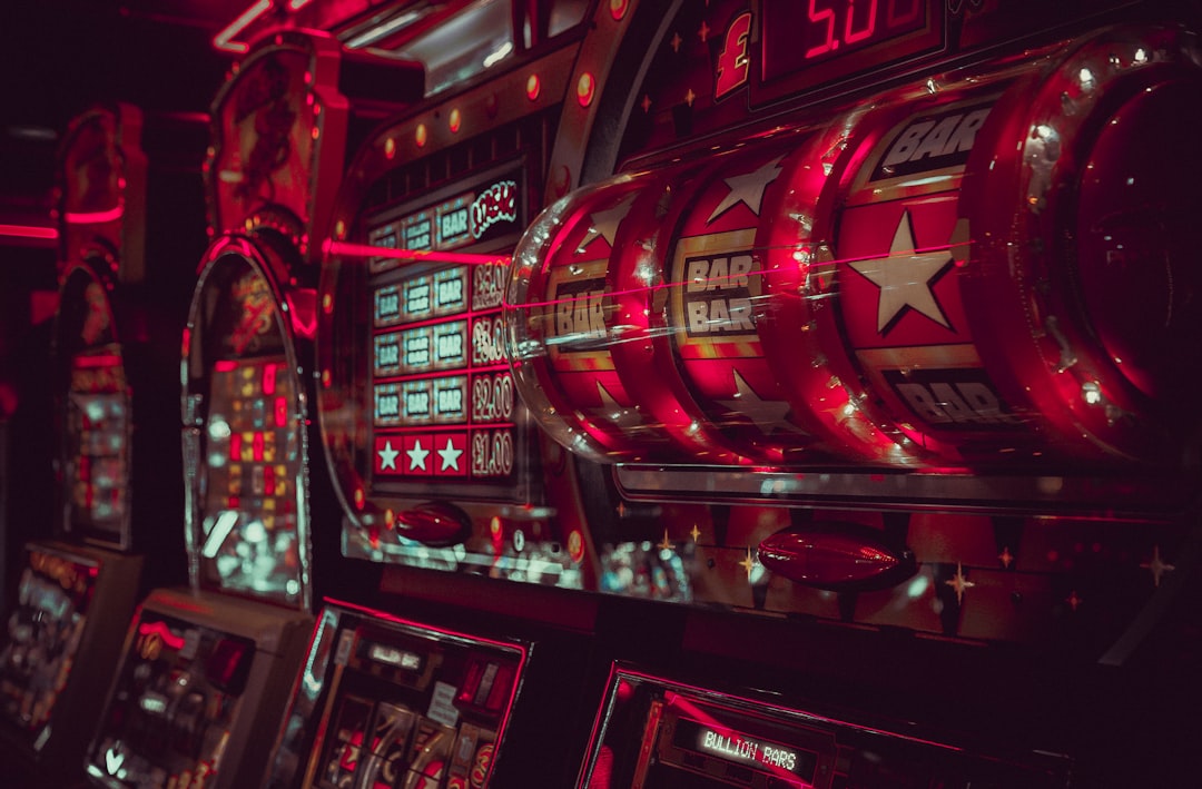 Close-up view of multiple vintage slot machines with vibrant red lights